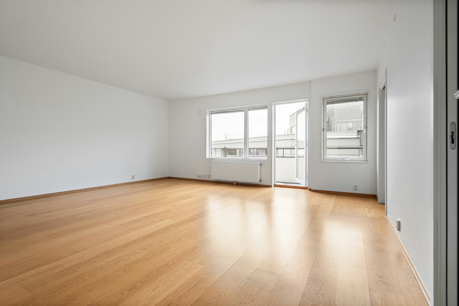 Bright empty living room before and warm-transitional staged after — empty